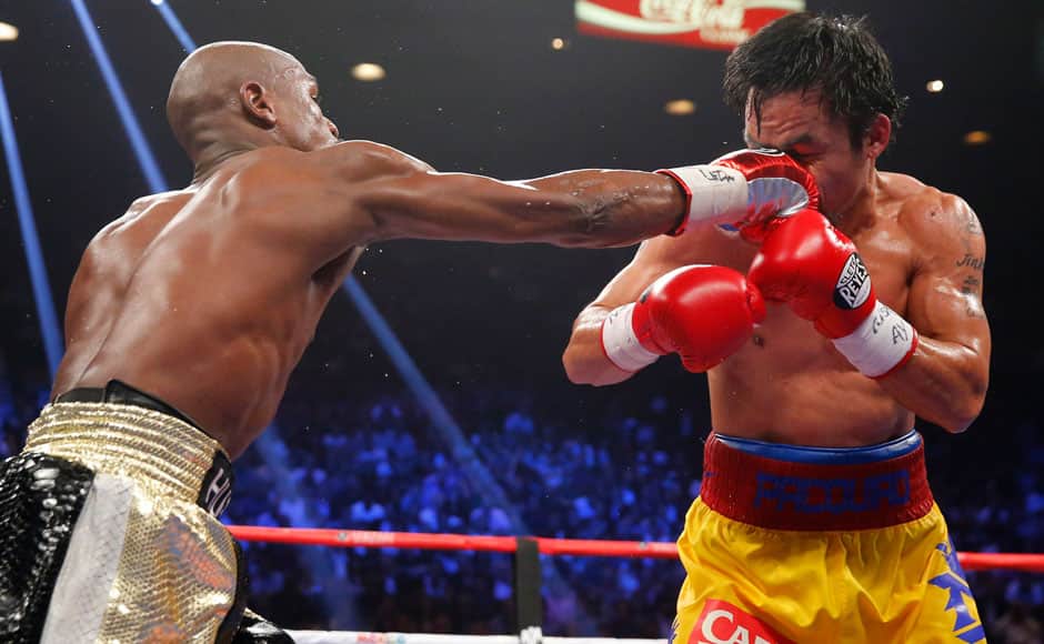 Floyd Mayweather, Jr. of the U.S. (L) lands a right against Manny Pacquiao of the Philippines in the sixth round during their welterweight WBO, WBC and WBA (Super) title fight in Las Vegas, Nevada, May 2, 2015. REUTERS