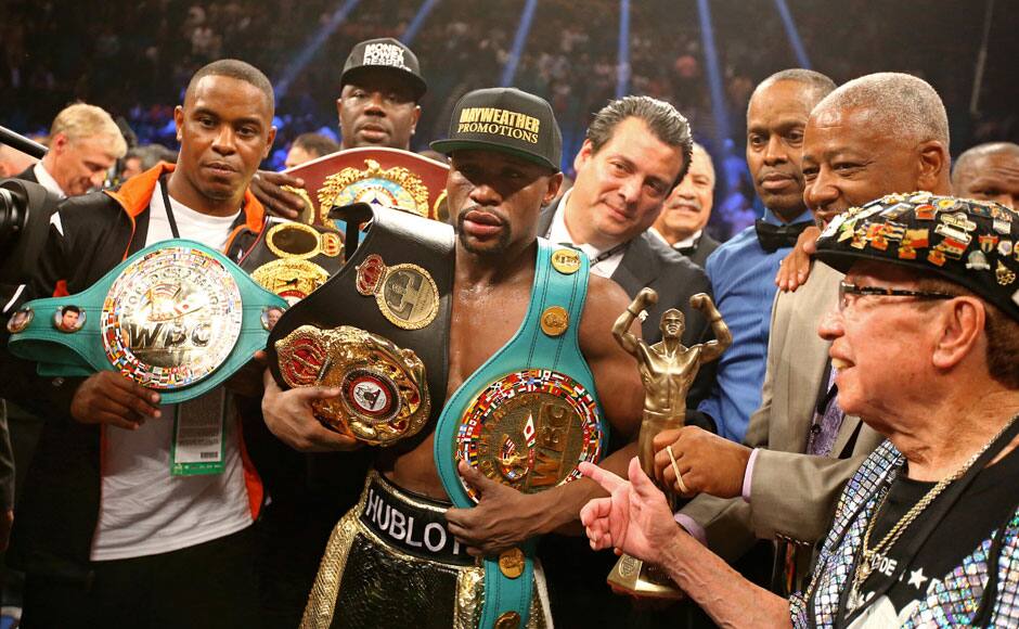  Las Vegas, NV, USA; Floyd Mayweather Jr celebrates with the championship belts after defeating Manny Pacquiao (not pictured) after 12 rounds in a unanimous judges decision during a boxing fight at the MGM Grand Garden Arena. Photo Credit: Mark J. Rebilas-USA TODAY Sports