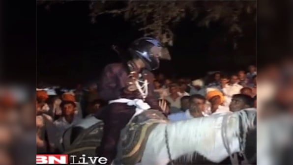 Dalit groom forced to wear helmet as upper caste Hindus hurl stones
