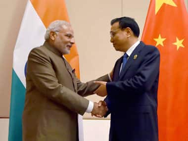 PM Modi and Premier Li. PTI