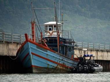 Malaysian Maritime police inspect one of the boats which carried illegal migrants in Langkawi. AFP