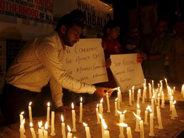 Members of the Shi’ite community light candles for the victims of Karachi bus attack. Reuters