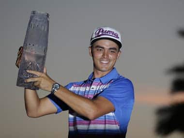 Rickie Fowler holding the trophy. AP