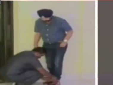Screenshot from Youtube video showing the guard tying the minister’s shoelaces.