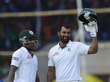 Tamim Iqbal (R) reacts after scoring a century (100 runs) as teammate Imrul Kayes (L) looks on. AFP