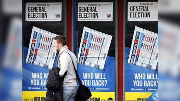 Polling begins in Britain elections, Labour's Miliband casts his vote