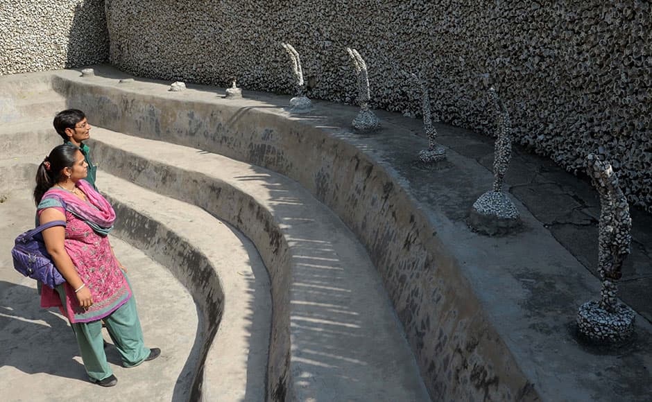An Indian visitor looks at sculptures at the Rock Garden in Chandigarh on February 2, 2009. The Rock Garden, which spreads over 40 acres, was built by Indian man Nek Chand from industrial and home waste and other disgarded items. AFP