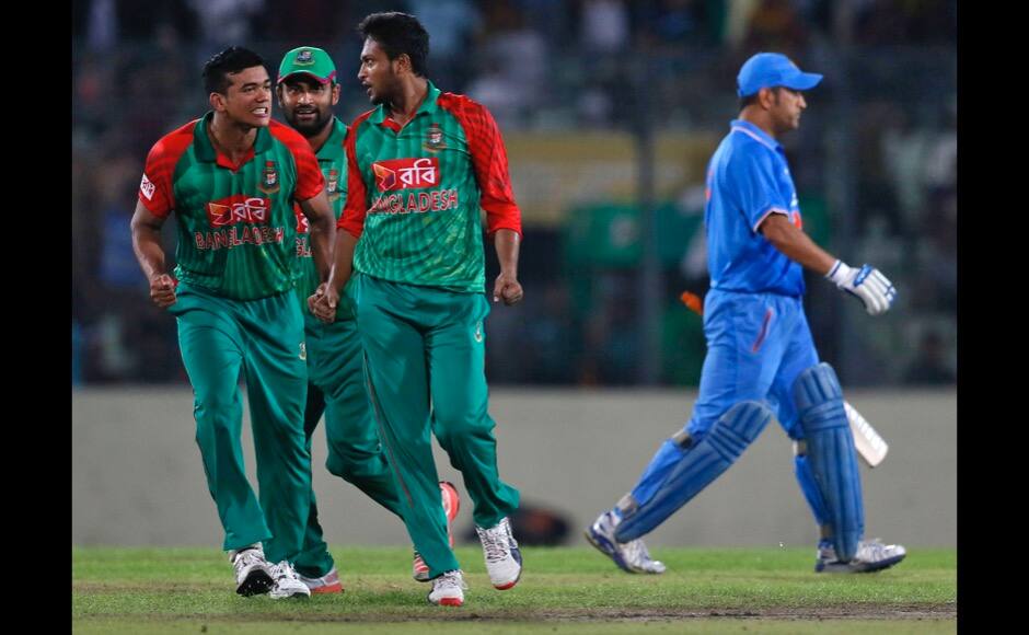 Bangladesh’s Shakib Al Hasan, second right, celebrates with teammates Taskin Ahmed, left, and Tamim Iqbal, second left, the dismissal of India’s captain MS Dhoni, right, during the first one-day international cricket match between them in Dhaka, Bangladesh, Thursday, June 18, 2015. (AP Photo/ A.M. Ahad) 