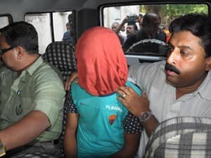 Police officials escorted Nazrul Islam to court on June 18th. AFP