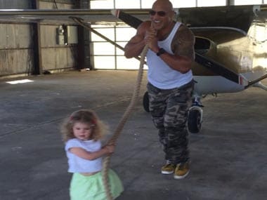 Dwayne 'The Rock' Johnson helps a 2-year-old pull a plane: see the video