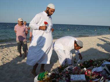Residents of the coastal town of Sousse in Tunisia place flowers and messages at the scene of Friday's shooting attack. AP