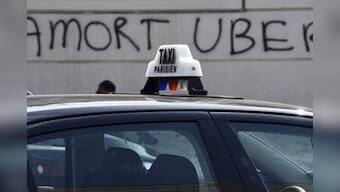 Fires and road blocks: French taxi drivers protest violently against Uber in Paris