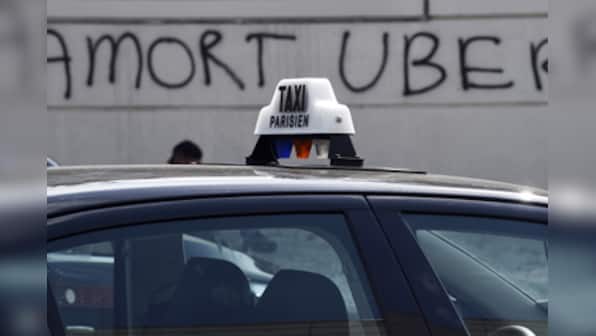 Fires and road blocks: French taxi drivers protest violently against Uber in Paris