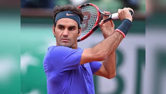 French Open: Tsonga ousts Berdych but Federer's match hangs in the balance on rain-hit day