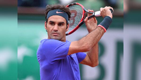 French Open: Tsonga ousts Berdych but Federer's match hangs in the balance on rain-hit day