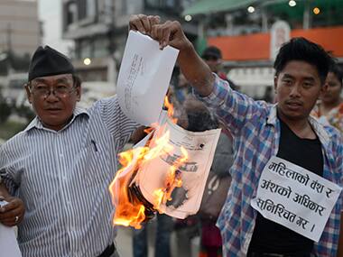 Nepalese activists, burn a copy of the draft constitution. AFP