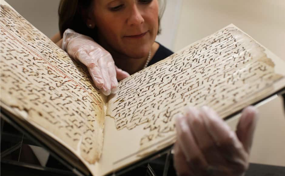 Conservator, Marie Sviergula holds a fragment of a Koran manuscript in the library at the University of Birmingham in Britain July 22, 2015. A British university said on Wednesday that fragments of a Koran manuscript found in its library were from one of the oldest surviving copies of the Islamic text in the world, possibly written by someone who might have known Prophet Mohammad. Radiocarbon dating indicated that the parchment folios held by the University of Birmingham in central England were at least 1,370 years old, which would make them one of the earliest written forms of the Islamic holy book in existence. REUTERS
