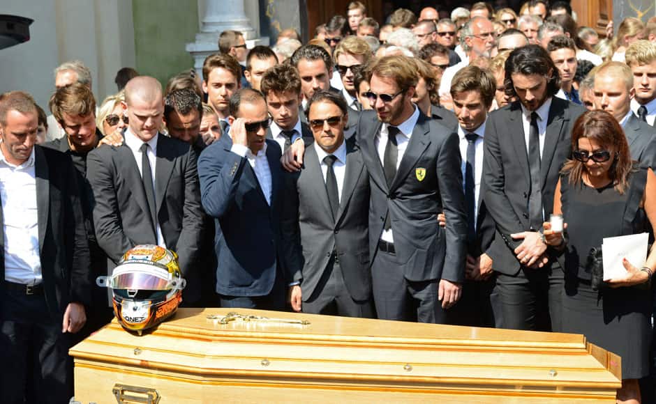 Formula One drivers Jean-Eric Vergne (4thR) and Felipe Massa (C), friends and relatives gather around the coffin of late Marussia F1 driver Jules Bianchi during the funeral ceremony at the Sainte Reparate Cathedral in Nice, France, July 21, 2015. Bianchi, 25, died in hospital in Nice on Friday, nine months after his crash at Suzuka in Japan and without regaining consciousness. REUTERS