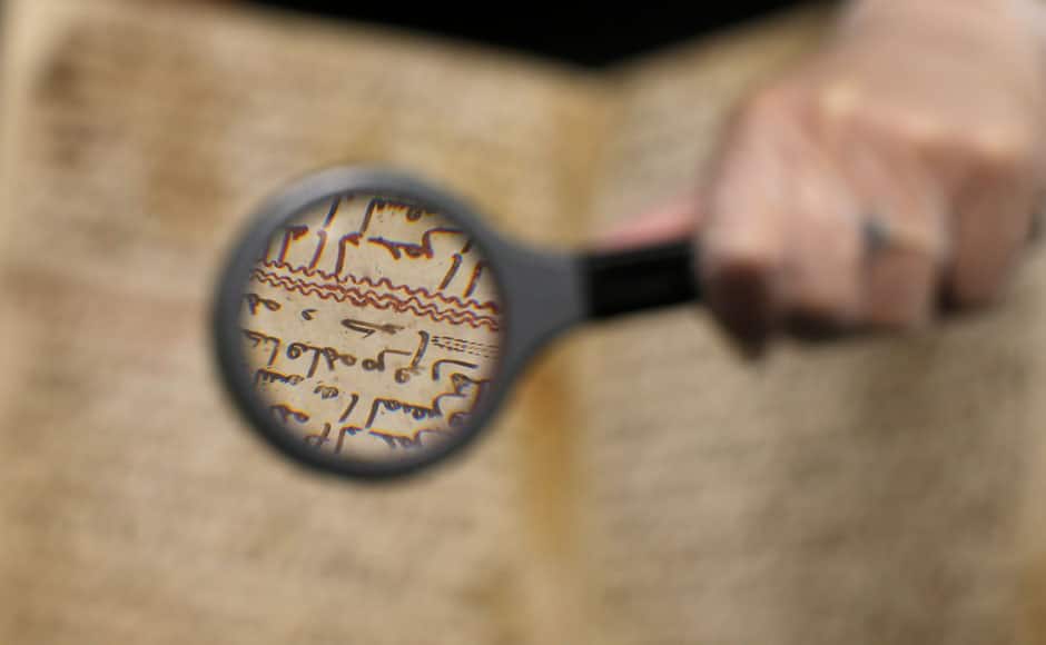 A detail of a fragment of a Koran manuscript is seen through a magnifying glass in the library at the University of Birmingham in Britain July 22, 2015. A British university said on Wednesday that fragments of a Koran manuscript found in its library were from one of the oldest surviving copies of the Islamic text in the world, possibly written by someone who might have known Prophet Mohammad. Radiocarbon dating indicated that the parchment folios held by the University of Birmingham in central England were at least 1,370 years old, which would make them one of the earliest written forms of the Islamic holy book in existence. REUTERS