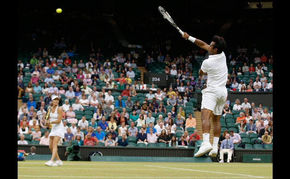 Leander Paes of India, right, and Martina Hingis of Switzerland serve during the mixed doubles final against Alexander Peya of Austria and Timea Babos of Hungary at the All England Lawn Tennis Championships in Wimbledon, London, Sunday July 12, 2015. (AP Photo/Pavel Golovkin)