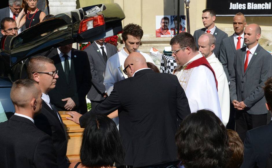 Philippe Bianchi, father of late Marussia Formula One driver Jules Bianchi, touches the coffin of his son at the start of the funeral ceremony at the Sainte Reparate Cathedral in Nice, France, July 21, 2015. Bianchi, 25, died in hospital in Nice on Friday, nine months after his crash at Suzuka in Japan and without regaining consciousness. REUTERS
