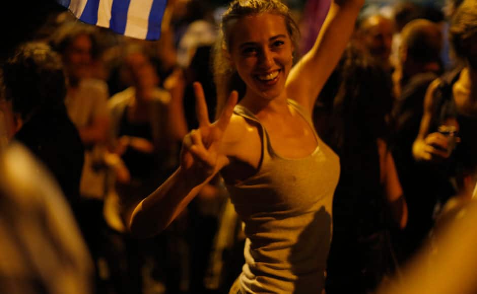 A supporter of the No vote makes the victory sign after the results of the referendum at Syntagma square in Athens, Sunday, July 5, 2015. Greeks overwhelmingly rejected creditors' demands for more austerity in return for rescue loans in a critical referendum Sunday, backing Prime Minister Alexis Tsipras, who insisted the vote would give him a stronger hand to reach a better deal. AP