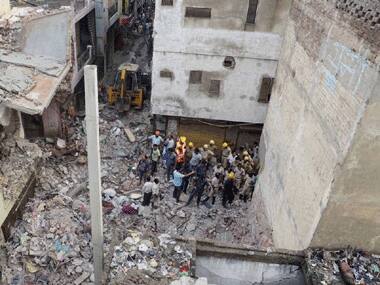 NDRF personnel along with locals during rescue operations after a four-storey building collapsed in the Vishnu Garden area of West Delhi on Sunday. PTI 