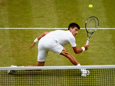 Novak Djokovic plays a backhand volley against Roger Federer in the Wimbledon final. Getty
