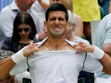 Novak Djokovic changes his shirt during his Men's Singles Final match against Roger Federer. Getty 