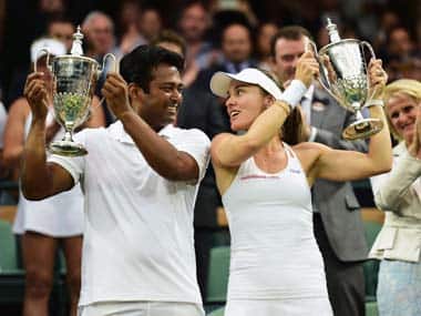 Leander Paes and Martina Hingis with their Wimbledon trophies. Getty Sports