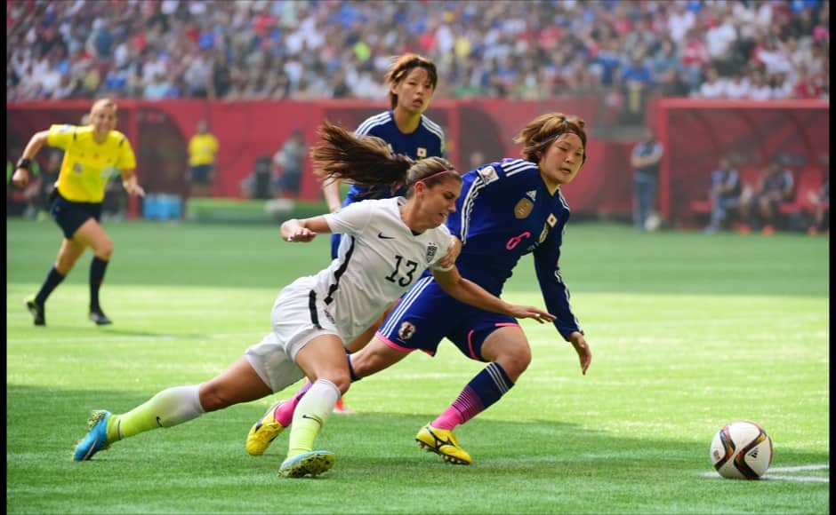 Jul 5, 2015; Vancouver, British Columbia, CAN; United States forward Alex Morgan (13) and Japan midfielder Mizuho Sakaguchi (6) chase a loose ball in the first half of the final of the FIFA 2015 Women's World Cup at BC Place Stadium. Mandatory Credit: Anne-Marie Sorvin-USA TODAY Sports - RTX1J51W