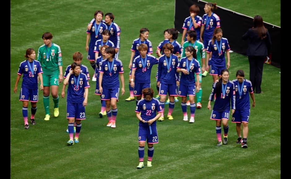 Jul 5, 2015; Vancouver, British Columbia, CAN; Japan walks off after receiving their silver medals after losing to the United States in the final of the FIFA 2015 Women's World Cup at BC Place Stadium. United States won 5-2. Mandatory Credit: Erich Schlegel-USA TODAY Sports - RTX1J58Z