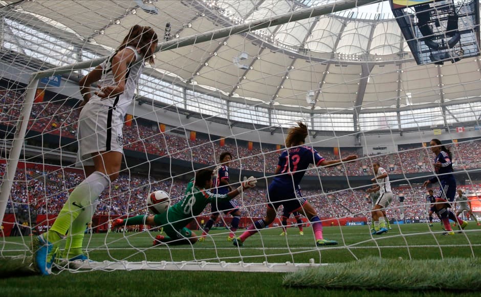Jul 5, 2015; Vancouver, British Columbia, CAN; United States midfielder Tobin Heath (17) scores against Japan goalkeeper Ayumi Kaihori (18) as United States forward Alex Morgan (13) stands in the goal in the second half of the final of the FIFA 2015 Women's World Cup at BC Place Stadium. United States won 5-2. Mandatory Credit: Michael Chow-USA TODAY Sports - RTX1J5CR