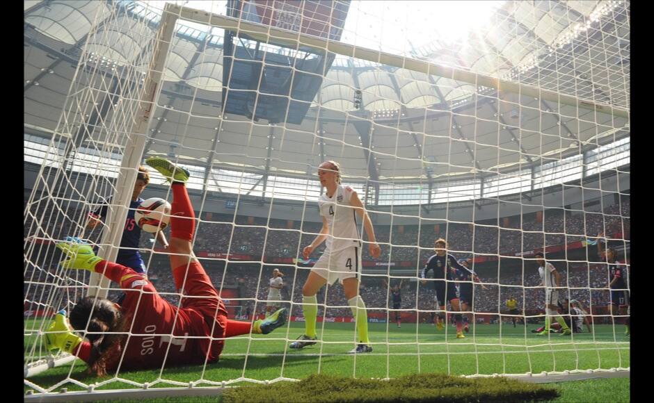 Jul 5, 2015; Vancouver, British Columbia, CAN;United States goalkeeper Hope Solo (1) dives but cannot stop an own goal score by United States defender Julie Johnston against Japan in the final of the FIFA 2015 Women's World Cup at BC Place Stadium. Looking on is United States defender Becky Sauerbrunn (4). The United States won 5-2. Mandatory Credit: Anne-Marie Sorvin-USA TODAY Sports - RTX1J5DV