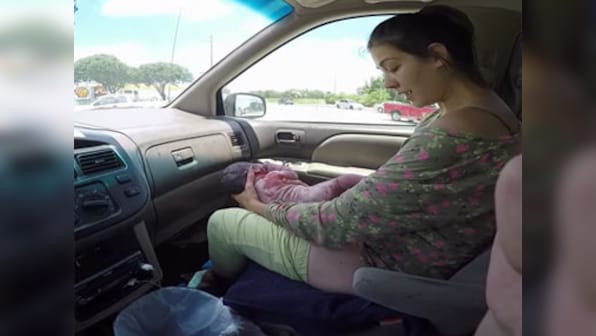 Caught on video: Man films wife giving birth in front seat of car amid hospital dash 