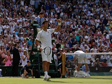 Novak Djokovic celebrates after beating Australia's Bernard Tomic during their men's singles third round match on day five. AFP Photos.