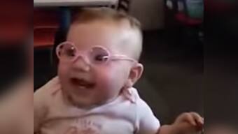 20-20 vision! Baby can't stop smiling after putting on new glasses