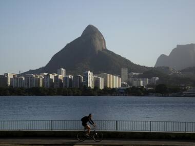 A cyclist rides along the Rodrigo de Freitas Lagoon in Rio de Janeiro. Reuters