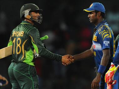 Shoaib Malik (L) is congratulated by Sri Lanka captain Angelo Mathews (C) after their victory in the fourth One Day International in Colombo. AFP