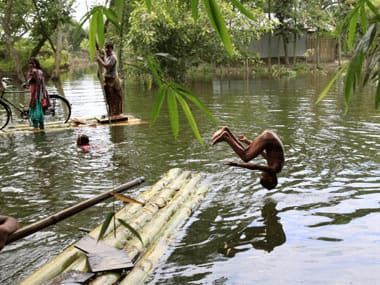 File photo. A boy jumps into floodwaters in Kurigram. Reuters