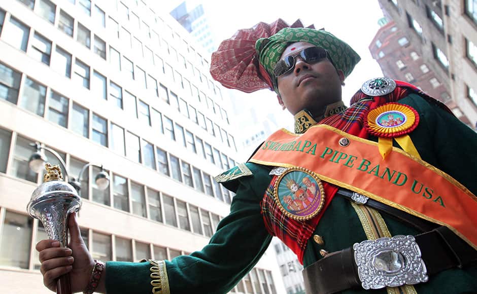 Tarkesh Patek, drum major with Swamibapa Pipe Band USA, waits to take part in the India Day Parade Sunday, Aug. 16, 2015, in New York. (AP/Tina Fineberg)