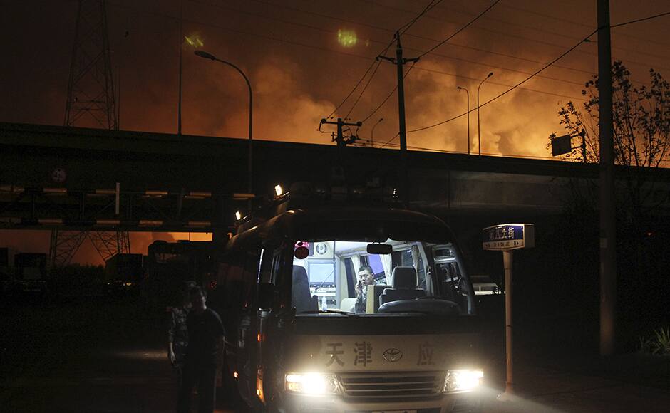 Rescuers are seen in a van near the site of the blasts at Binhai new district in Tianjin municipality, China, August 13, 2015. REUTERS/Stringer