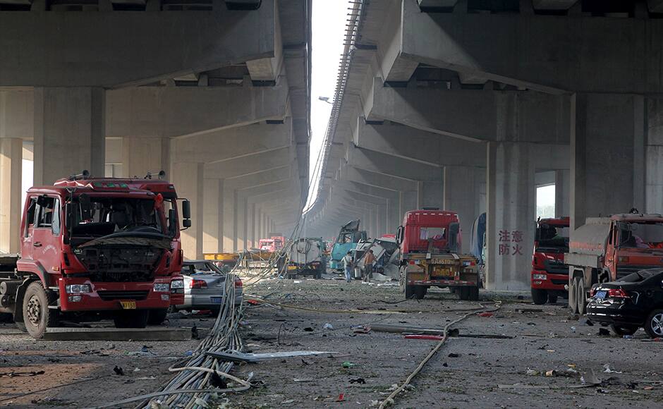 Damaged vehicles are seen under bridges close to the site of the explosions at Binhai new district, Tianjin, August 13, 2015. Two massive explosions caused by flammable goods ripped through an industrial area in the northeast Chinese port city of Tianjin late on Wednesday, killing 17 people and injuring around 400, official Chinese media reported. REUTERS/Stringer