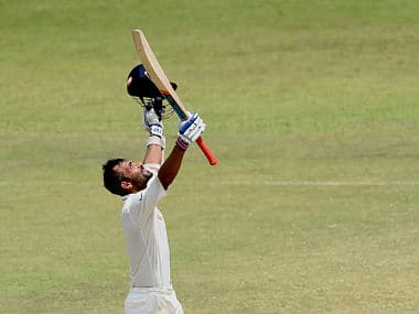 Ajinkya Rahane raises his bat and helmet in celebration after scoring century. AFP