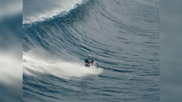 Must watch: Australian stuntman surfs massive wave on a motorbike