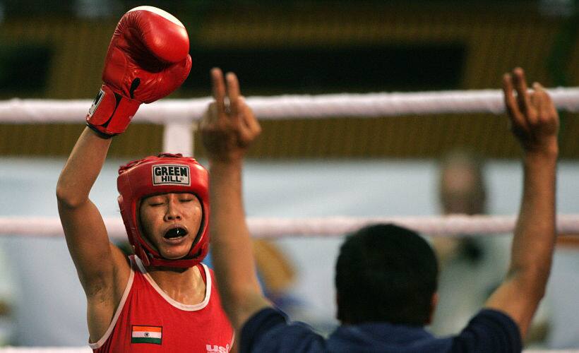 Sarita Devi (L) celebrates winning gold in the 52 Kg weight category at World Women Boxing Championship in New Delhi. AFP