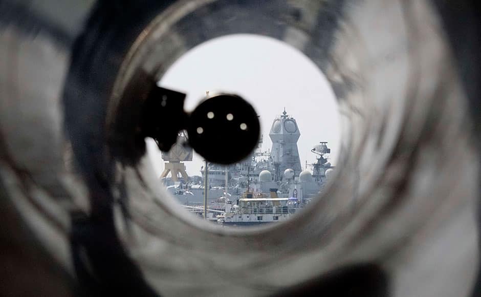 A naval vessel is seen through the barrel of an Indegenous Rocket Launcher on board the INS Kochi which will be commissioned into the Indian Navy on Wednesday, in Mumbai, India on September 28, 2015. Kochi is the second ship of the indigenously designed and constructed Project 15A (Kolkata-class) guided missile destroyer, built by Mazagon Dock Shipbuilders. INS Kochi incorporates new design concepts for stealth and has many firsts to her credit, including a very large component of indigenous combat-suite. The ship is packed with the most sophisticated state-of-the-art weapons and sensors including the vertically launched Long Range Surface to Air Missiles (LRSAM) and MF-STAR multi-function active phased array radar, which is fitted only on the Kolkata class of ships. She is equipped with the advanced supersonic and long range BrahMos Surface to Surface Missile - a joint Indo-Russian venture. The 76 mm Super Rapid Gun Mount (SRGM) and AK 630 CIWS, both manufactured indigenously, can take on air and surface targets. SOLARIS IMAGES
