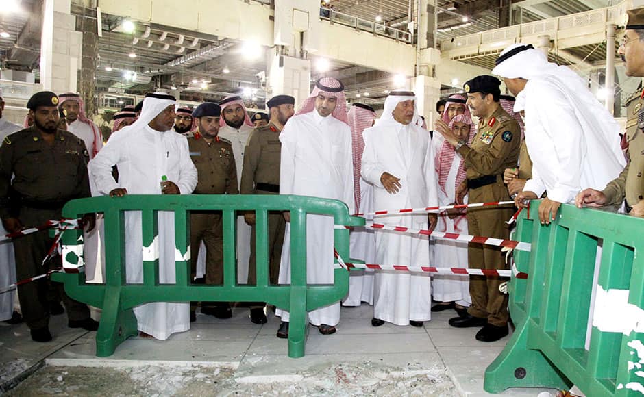 Saudi governor of Mecca region Khaled al-Faisal (center R) inspects the site of a crane that crashed onto the Grand Mosque of Saudi Arabia's holy Muslim city of Mecca on September 12, 2015. A massive construction crane crashed into Mecca's Grand Mosque in stormy weather on, killing at least 107 people and injuring 238, Saudi authorities said, days before the annual hajj pilgrimage. AFP PHOTO / STR