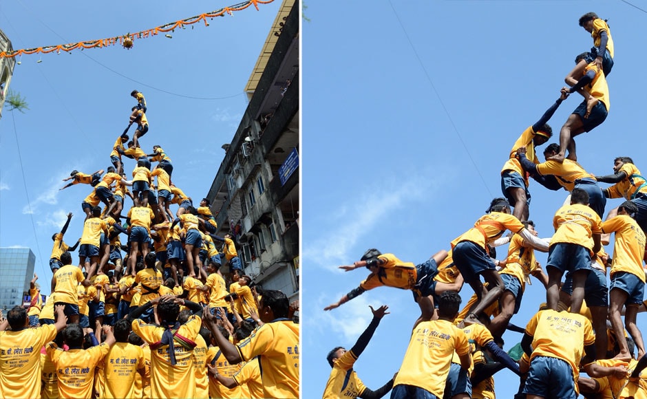 An Indian Hindu devotee (bottom L) falls during an attempt to form a human pyramid in a bid to reach and break a dahi-handi (curd-pot) suspended in the air during celebrations for the Janmashtami festival, which marks the birth of Hindu God Lord Krishna, in Mumbai on September 6, 2015. Participants receive prize money by constructing a human pyramid tall enough to enable the top person to reach the pot and claim the contents after breaking it. AFP PHOTO/ INDRANIL MUKHERJEE