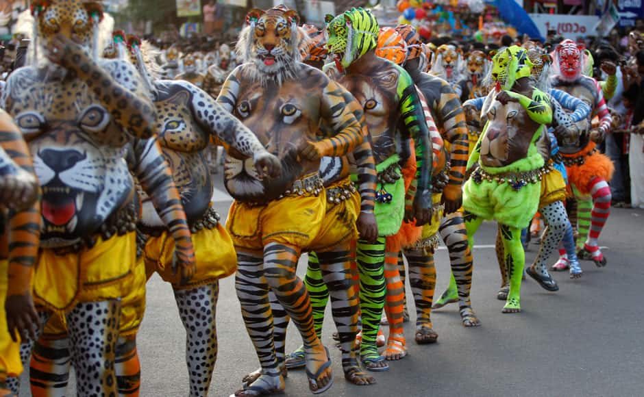 Indian artists with their bodies painted with the likeness of tigers perform during the 'Pulikali' or Tiger Dance procession in Thrissur, Kerala state, India, Monday, Aug. 31, 2015. This folk art festival is held every year in this town to entertain people during the harvest festival ‘Onam’. (AP Photo/Arun Sankar K.)